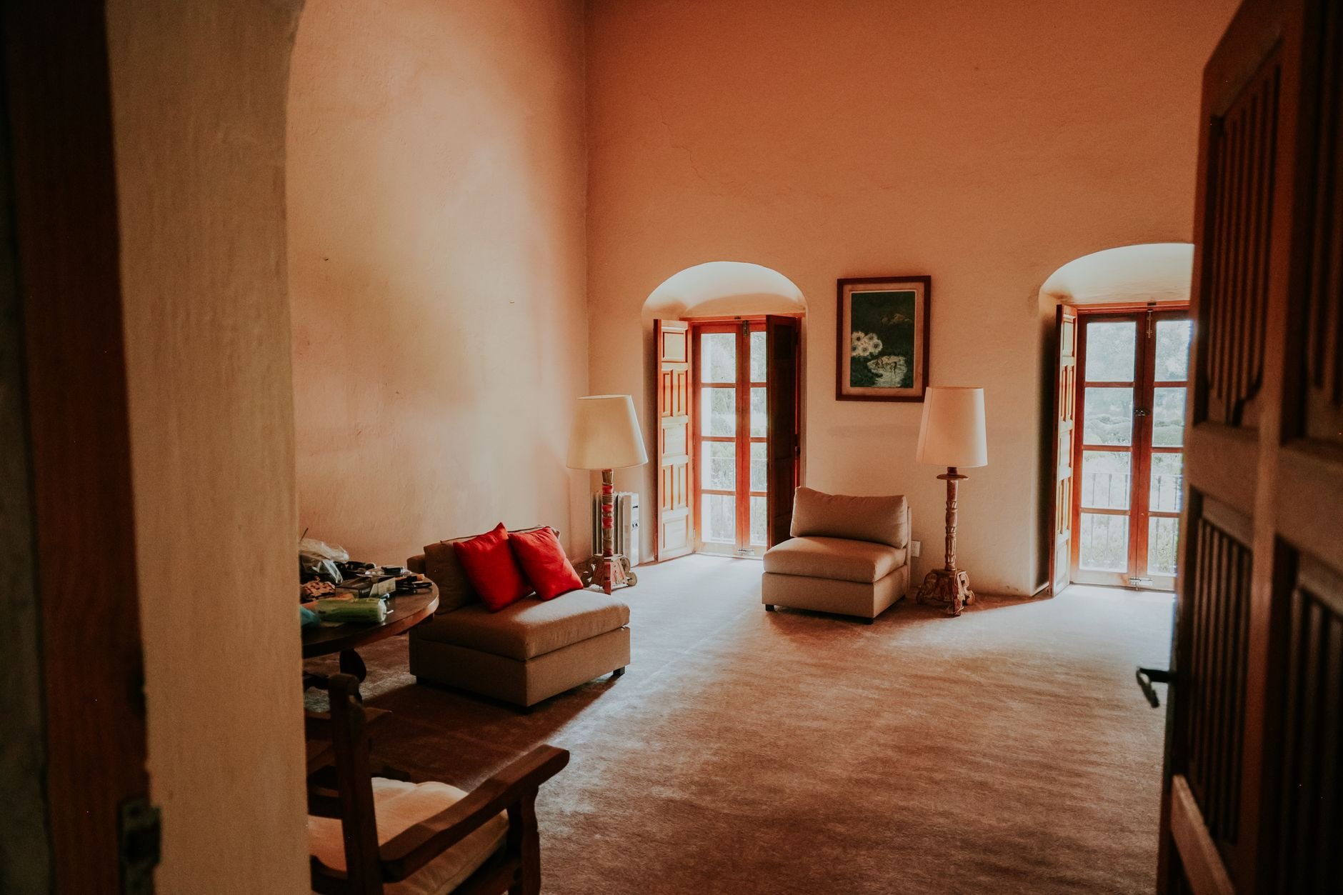 Inviting living room with armchairs and natural light through arched windows
